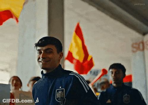 A Man Wearing A Blue Jacket With The Word Adidas On The Front GIF