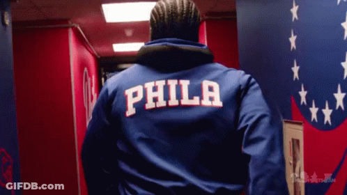 A Man Wearing A Blue Jacket With The Word Phila On The Back GIF