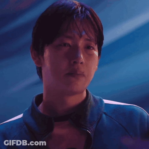 A Man Wearing A Blue Jacket With White Stripes On The Sleeves GIF