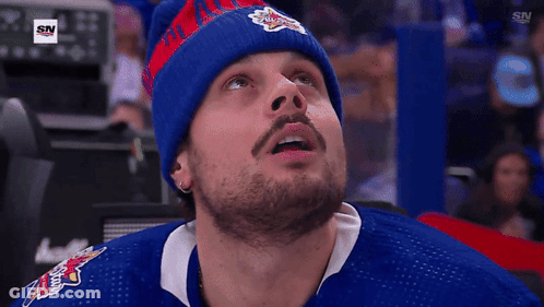 A Man Wearing A Blue Jersey With A Sn Logo On The Bottom GIF