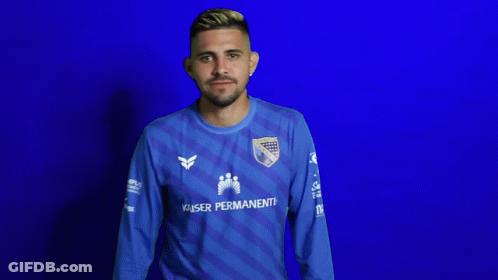 A Man Wearing A Blue Kaiser Permanente Jersey Looks Down GIF