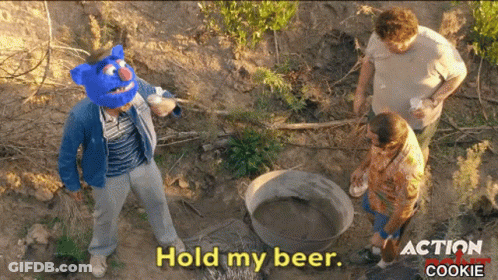 A Man Wearing A Blue Mask Says Hold My Beer GIF
