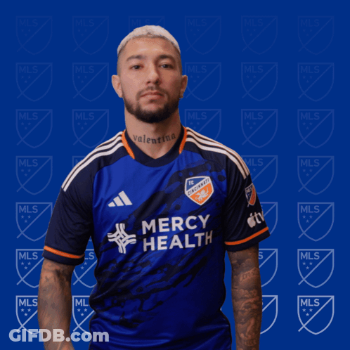 A Man Wearing A Blue Mercy Health Jersey GIF