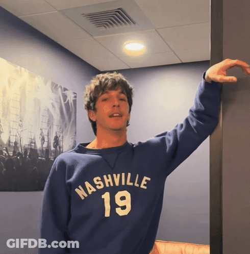 A Man Wearing A Blue Nashville 19 Sweatshirt GIF