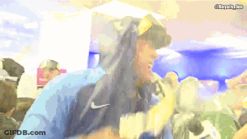 A Man Wearing A Blue Nike Hoodie Stands In Front Of A Camera GIF
