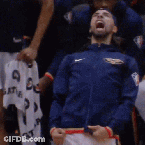 A Man Wearing A Blue Nike Jacket Is Screaming In The Stands GIF