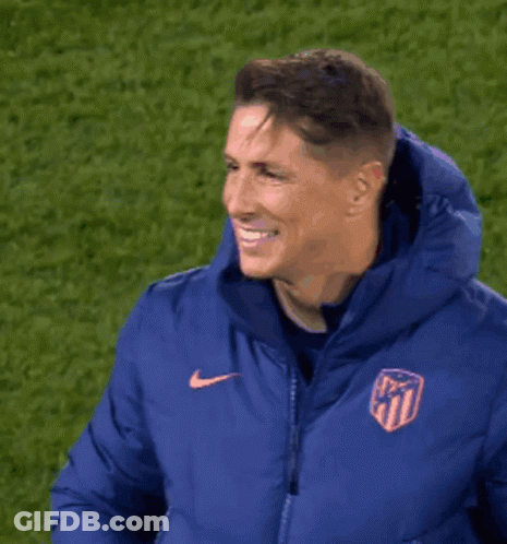 A Man Wearing A Blue Nike Jacket With A Crest On It GIF