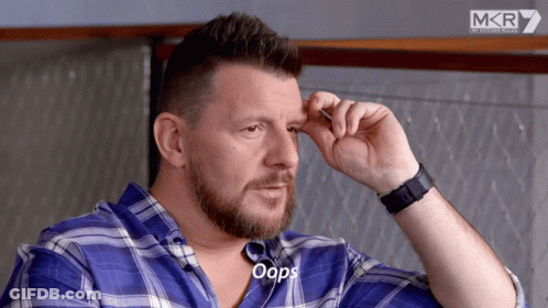 A Man Wearing A Blue Plaid Shirt And A Black Watch Says Oops GIF