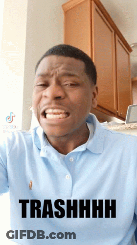 A Man Wearing A Blue Polo Shirt Is Making A Funny Face And Has The Word Trashhhh On His Shirt GIF