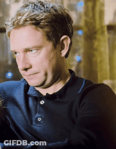 A Man Wearing A Blue Polo Shirt With Buttons On It GIF