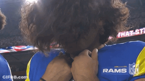 A Man Wearing A Blue Rams Jersey Covering His Face With His Hands GIF