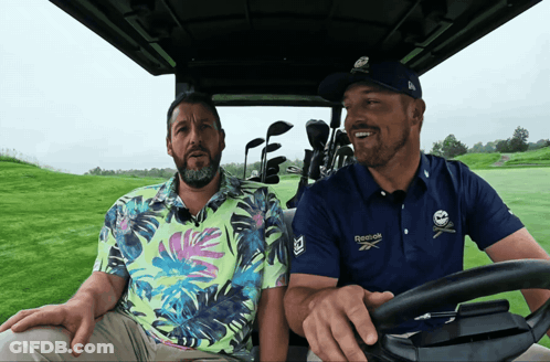 A Man Wearing A Blue Reebok Shirt Is Driving A Golf Cart GIF