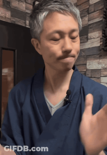 A Man Wearing A Blue Robe With A Microphone On It GIF
