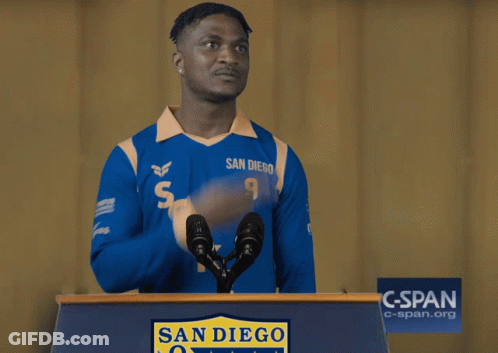 A Man Wearing A Blue San Diego Jersey Stands Behind A Podium GIF