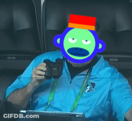 A Man Wearing A Blue Shirt And A Green Monkey Mask GIF