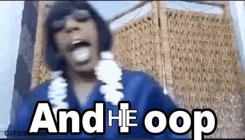 A Man Wearing A Blue Shirt And A Lei Is Making A Funny Face And Says And He Oops . GIF
