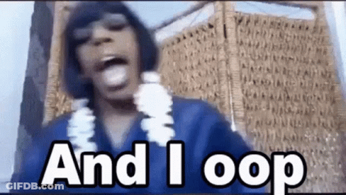 A Man Wearing A Blue Shirt And A Lei Says `` And I Loop '' While Standing In Front Of A Wall . GIF