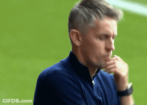 A Man Wearing A Blue Shirt And A Watch Looks Down At Something GIF