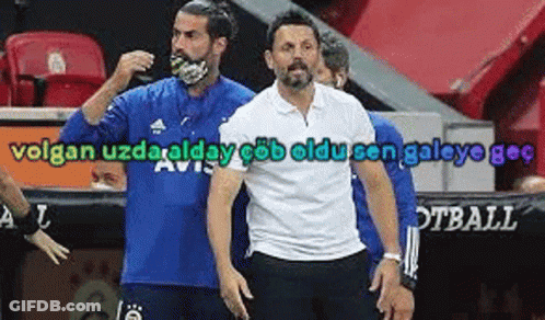 A Man Wearing A Blue Shirt And A White Shirt Is Standing Next To Another Man . GIF
