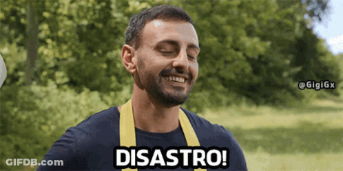 A Man Wearing A Blue Shirt And A Yellow Apron Is Smiling And Saying Disaster GIF