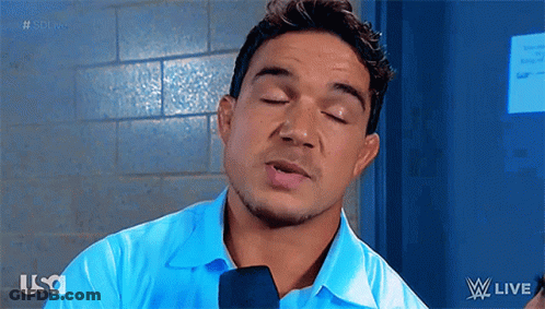 A Man Wearing A Blue Shirt And Tie Is Talking Into A Microphone While Watching W Live GIF
