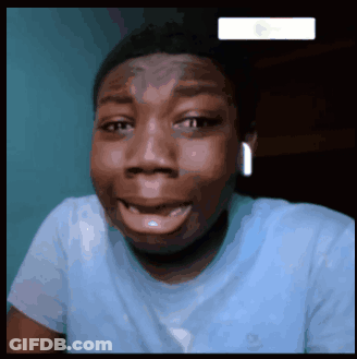 A Man Wearing A Blue Shirt Is Smiling And Making A Funny Face GIF