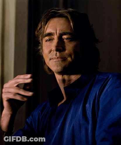 A Man Wearing A Blue Shirt Is Smoking A Cigarette GIF