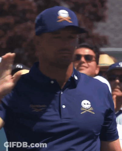 A Man Wearing A Blue Shirt That Has The Word Golf On The Sleeve GIF