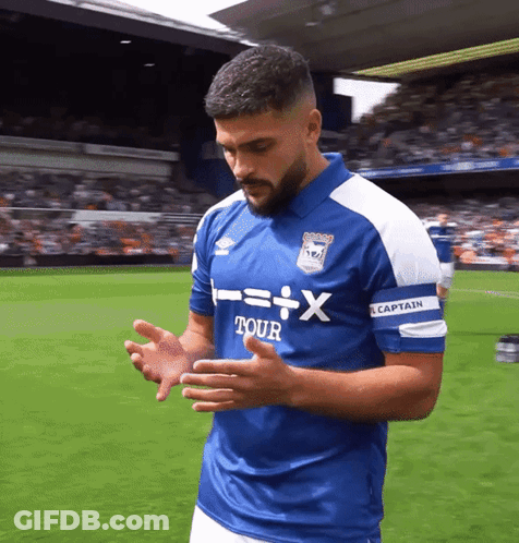 A Man Wearing A Blue Shirt That Says " Captain " On It GIF