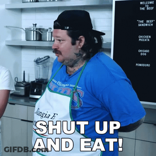 A Man Wearing A Blue Shirt That Says Chicago Cubs Is Saying Shut Up And Eat GIF