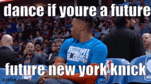 A Man Wearing A Blue Shirt That Says Dance If Youre A Future Future New York Knick Is Sitting In The Stands GIF
