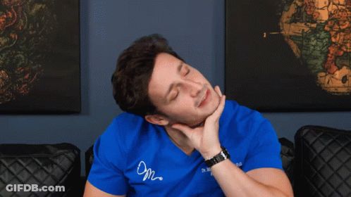 A Man Wearing A Blue Shirt That Says Dr. Mike Lombardi Is Holding His Neck GIF