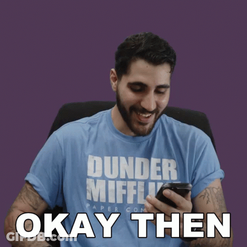 Man In Dunder Mifflin Shirt Looking At Phone GIF