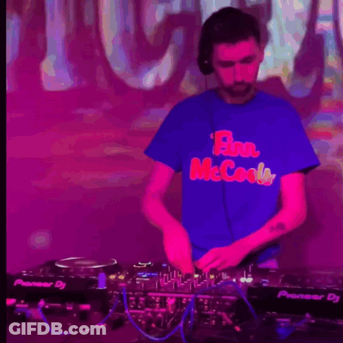 A Man Wearing A Blue Shirt That Says Flan Mccools Is Playing Music GIF