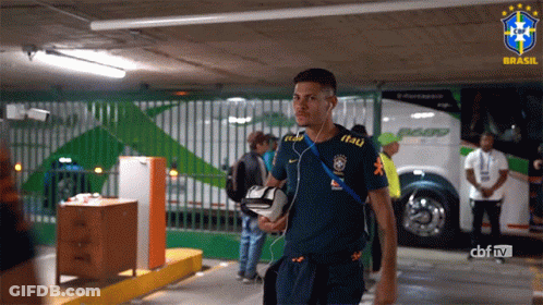 A Man Wearing A Blue Shirt That Says Itau On It GIF