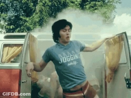 A Man Wearing A Blue Shirt That Says Jogging Is Standing In A Van . GIF