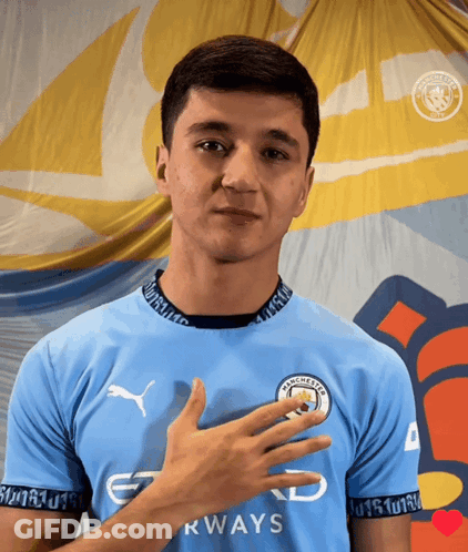 A Man Wearing A Blue Shirt That Says Manchester Airways On It GIF