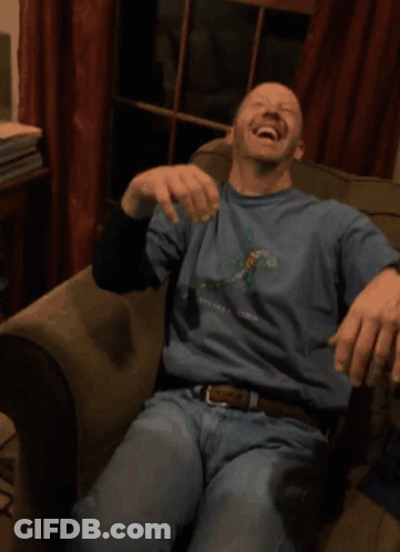 A Man Wearing A Blue Shirt That Says New York Is Laughing GIF