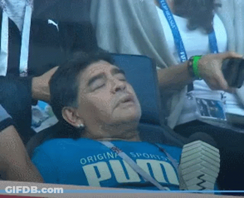 A Man Wearing A Blue Shirt That Says Puma Is Laying Down GIF