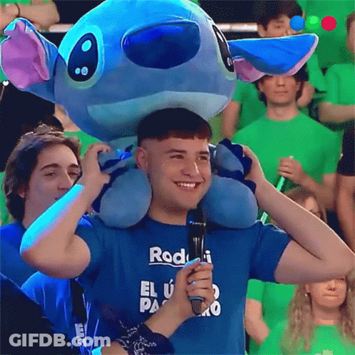 A Man Wearing A Blue Shirt That Says Rod Holds A Microphone GIF