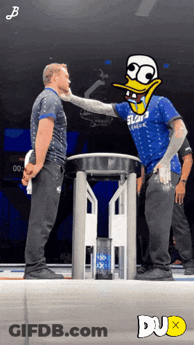 Man In Blue Slam Dunk Shirt Next To Another Man GIF