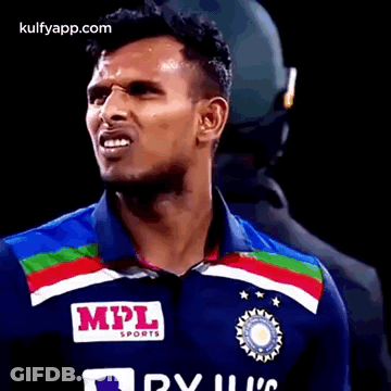 A Man Wearing A Blue Shirt With A Mpl Sports Logo On It . GIF