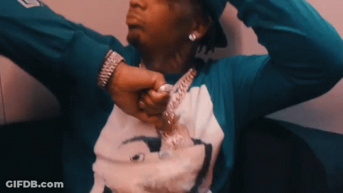 A Man Wearing A Blue Shirt With A Picture On It GIF