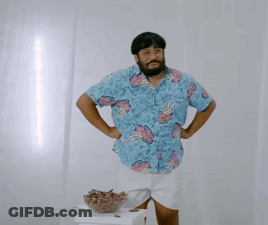 A Man Wearing A Blue Shirt With Pineapples On It GIF