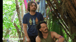 A Man Wearing A Blue Shirt With Robots On It Is Standing Next To Another Man GIF
