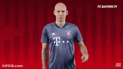 A Man Wearing A Blue Shirt With The Letter T. GIF