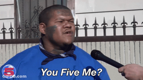A Man Wearing A Blue Shirt With The Number 5 On It Is Talking Into A Microphone GIF
