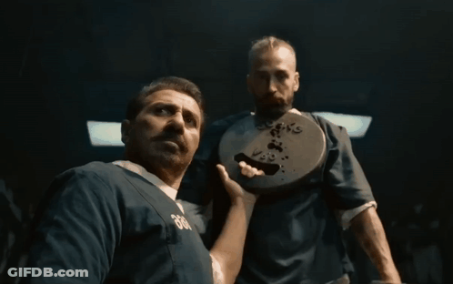 A Man Wearing A Blue Shirt With The Number 666 On It GIF