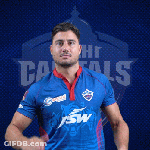 A Man Wearing A Blue Shirt With The Word Capitals On The Back GIF
