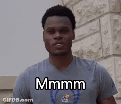 A Man Wearing A Blue Shirt With The Word Mmmm On It GIF